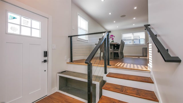 foyer entrance with hardwood / wood-style flooring and a wealth of natural light