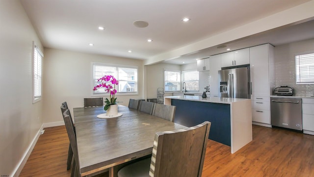 dining space featuring sink and dark wood-type flooring