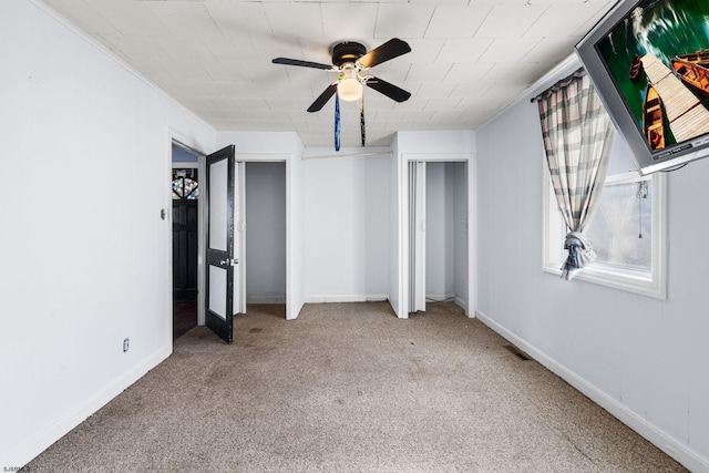 unfurnished bedroom with ceiling fan and light colored carpet