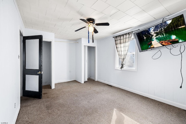 unfurnished bedroom with ceiling fan and carpet flooring