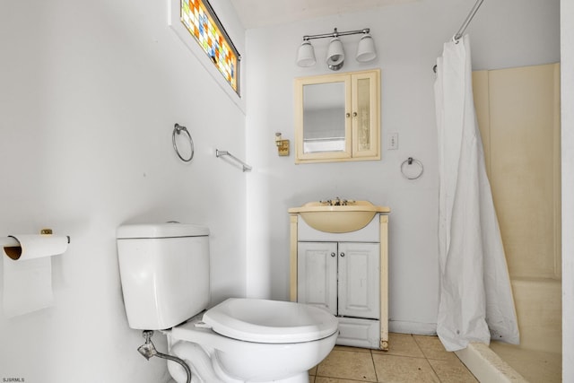 bathroom featuring toilet, tile patterned floors, walk in shower, and vanity