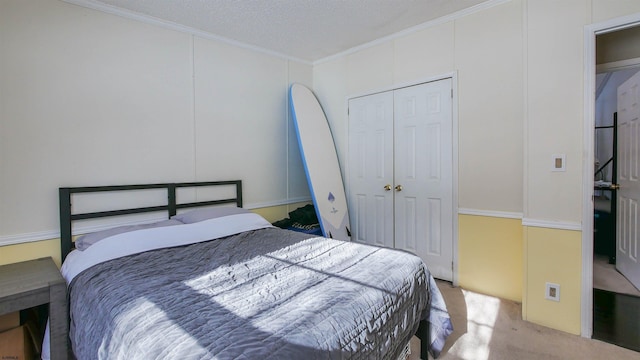 carpeted bedroom featuring a closet, a textured ceiling, and crown molding