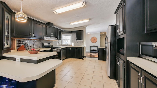 kitchen featuring appliances with stainless steel finishes, kitchen peninsula, light tile patterned floors, a kitchen bar, and decorative light fixtures