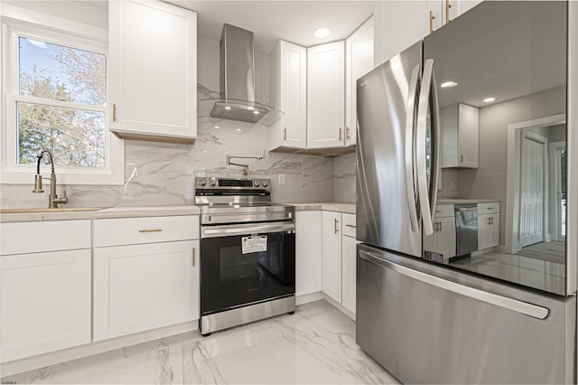 kitchen with sink, white cabinetry, wall chimney exhaust hood, tasteful backsplash, and appliances with stainless steel finishes