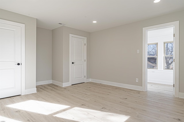 spare room with light hardwood / wood-style flooring