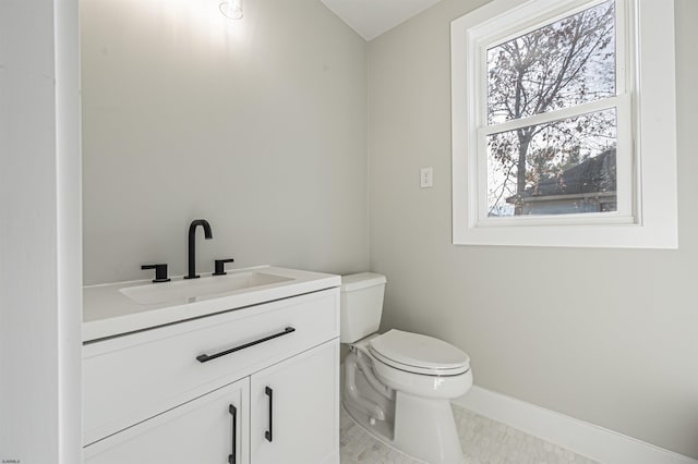 bathroom featuring toilet, tile patterned floors, and vanity