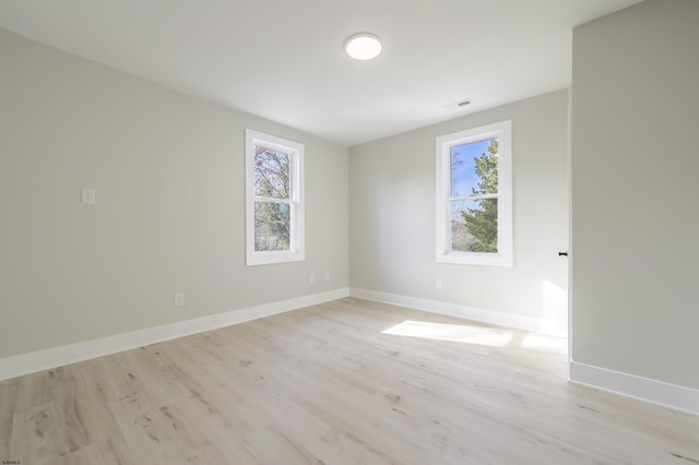 unfurnished room featuring light hardwood / wood-style floors