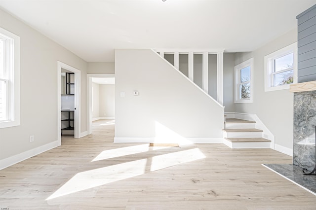 stairs featuring a premium fireplace and hardwood / wood-style floors