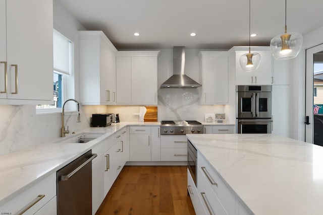 kitchen featuring white cabinets, wall chimney range hood, decorative backsplash, and sink