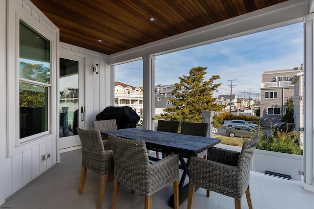 sunroom / solarium featuring wood ceiling