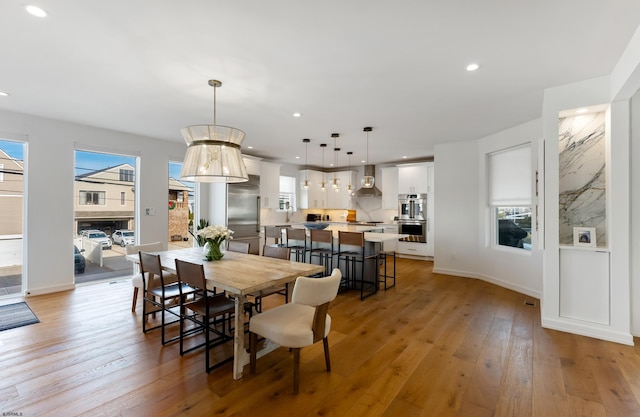 dining room with light hardwood / wood-style flooring and a wealth of natural light