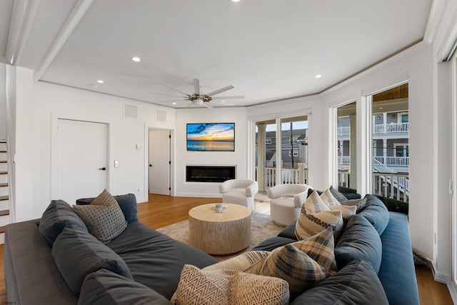 living room with ceiling fan and wood-type flooring