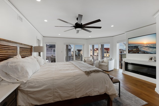 bedroom featuring ceiling fan, dark wood-type flooring, access to outside, and ornamental molding