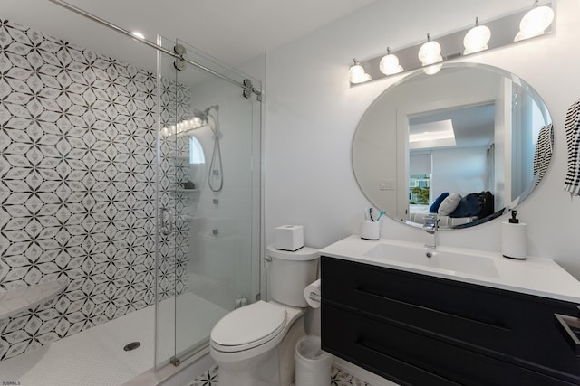 bathroom featuring walk in shower, vanity, and toilet