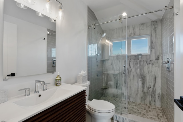 bathroom with toilet, a shower with door, and vanity