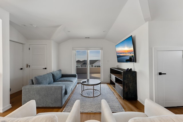 living room featuring light hardwood / wood-style floors and lofted ceiling