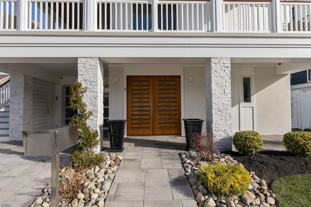 property entrance with french doors and a balcony