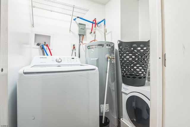 clothes washing area with washer and clothes dryer