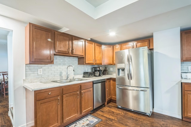 kitchen with backsplash, appliances with stainless steel finishes, dark hardwood / wood-style floors, and sink