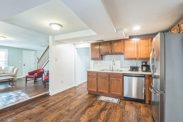 kitchen with sink, stainless steel appliances, decorative backsplash, and dark hardwood / wood-style floors