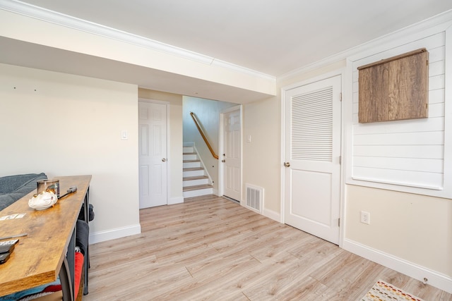 office area with crown molding and light hardwood / wood-style flooring