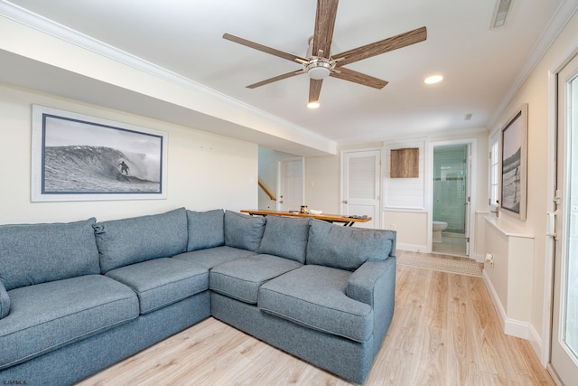 living room with ceiling fan, crown molding, and light hardwood / wood-style flooring