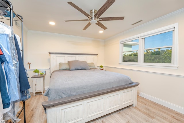 bedroom with ceiling fan, light hardwood / wood-style floors, and crown molding