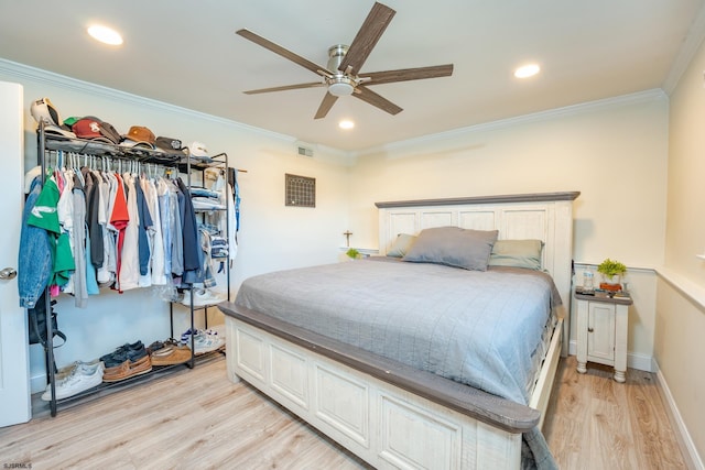 bedroom with ceiling fan, light hardwood / wood-style flooring, and ornamental molding