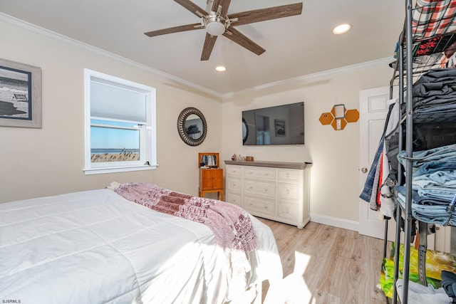 bedroom featuring ceiling fan, light wood-type flooring, and crown molding