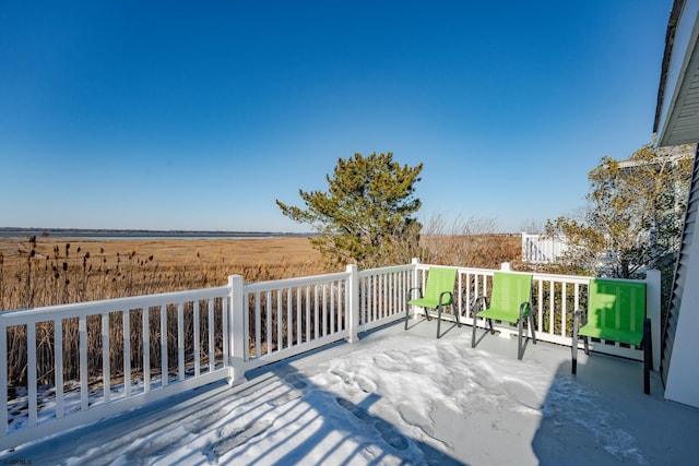 wooden deck with a rural view