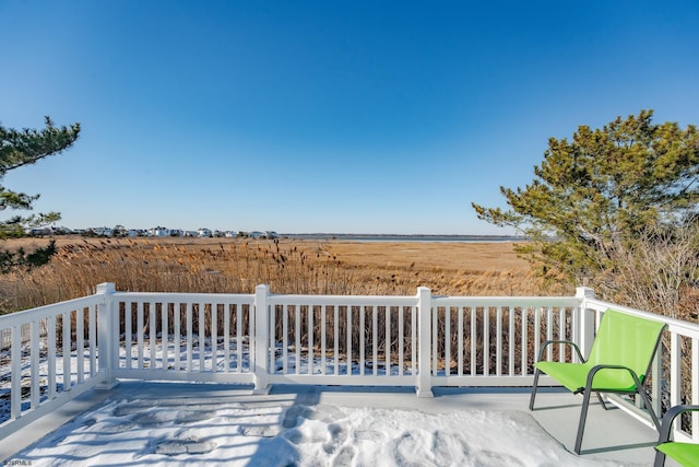 wooden deck with a rural view