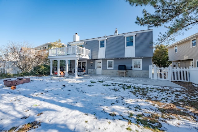 snow covered property featuring a deck