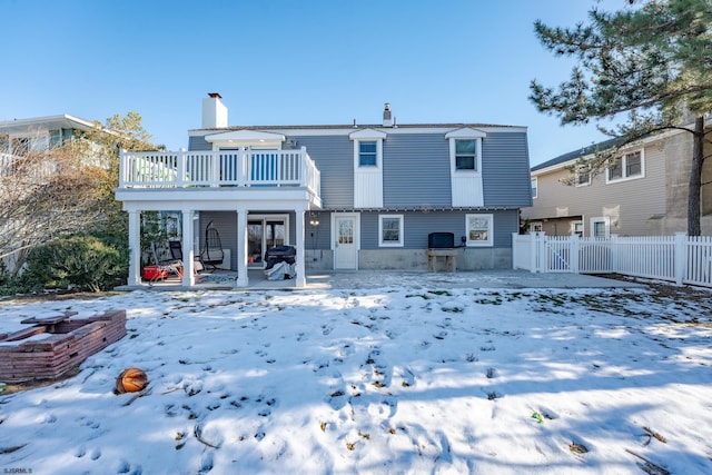 snow covered house with a balcony