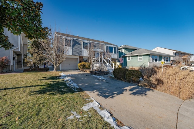 view of front of house with a front yard and a garage