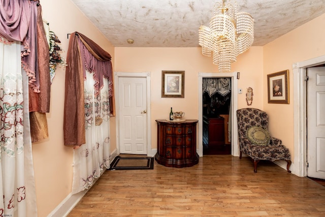 foyer with a notable chandelier and light hardwood / wood-style flooring