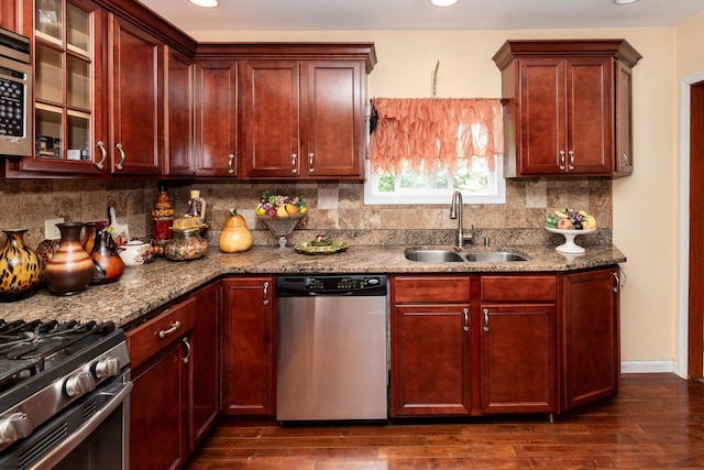 kitchen featuring light stone countertops, appliances with stainless steel finishes, dark hardwood / wood-style floors, and sink