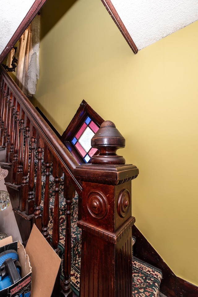 stairs featuring a textured ceiling