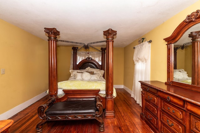 bedroom with dark wood-type flooring