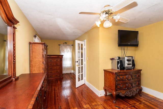 corridor with french doors, dark hardwood / wood-style flooring, a textured ceiling, and vaulted ceiling