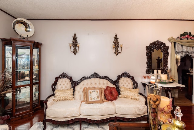 living area featuring a textured ceiling, ornamental molding, and dark hardwood / wood-style floors