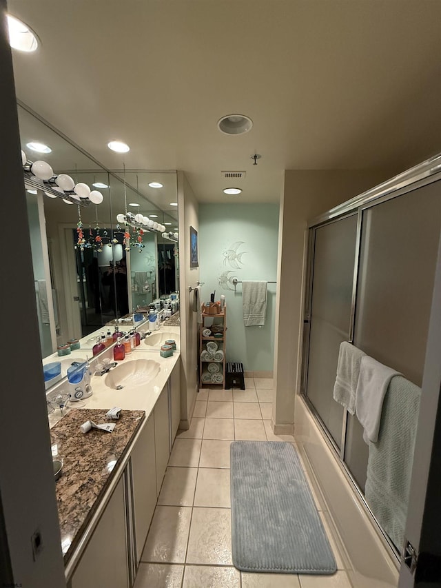 bathroom with shower / bath combination with glass door, tile patterned floors, and vanity