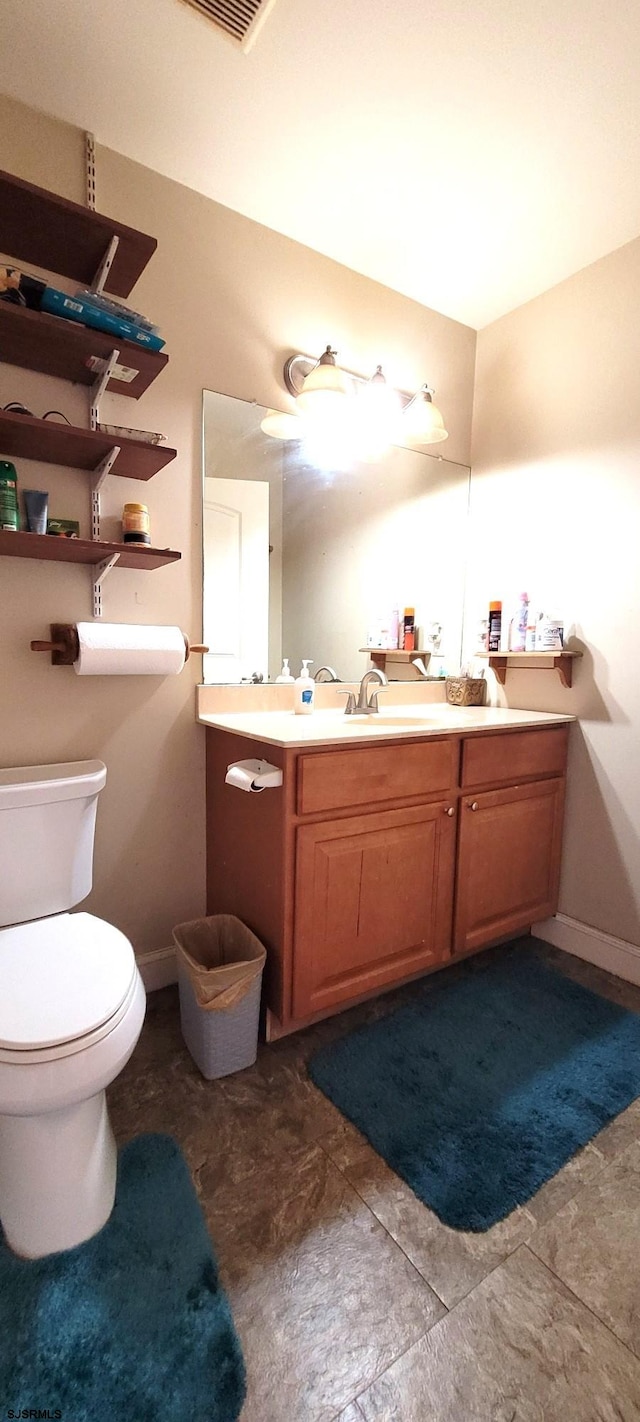 bathroom with toilet and vanity