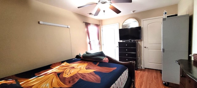 bedroom featuring ceiling fan and dark hardwood / wood-style flooring