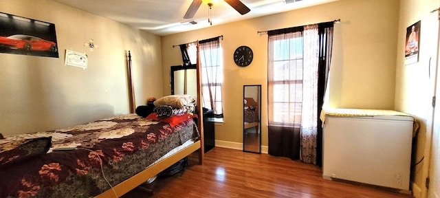 bedroom featuring ceiling fan and hardwood / wood-style flooring