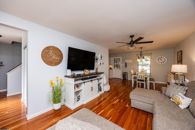 living room with ceiling fan and wood-type flooring