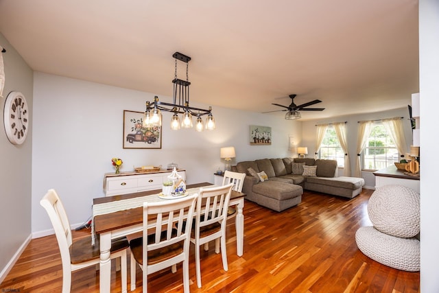 dining area with ceiling fan and dark wood-type flooring