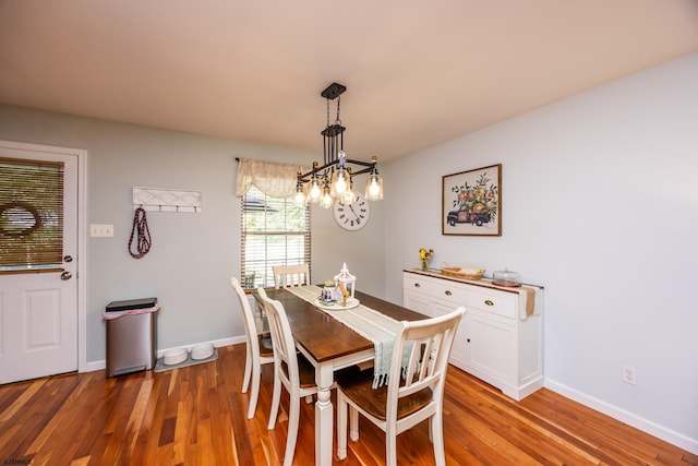 dining area featuring an inviting chandelier and light wood-type flooring