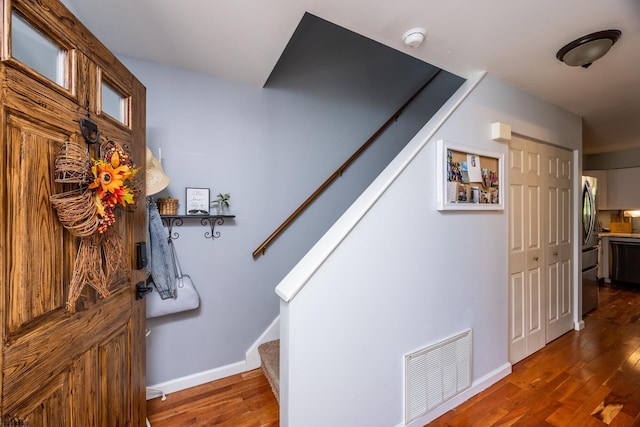 staircase featuring wood-type flooring