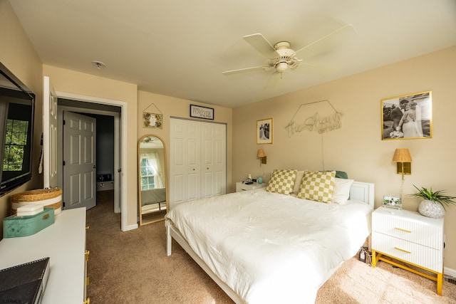 bedroom featuring ceiling fan, a closet, and dark carpet