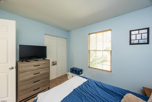 carpeted bedroom with a closet